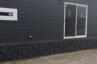 Textured Fieldstone Skirting for Monochromatic Charcoal Exterior
