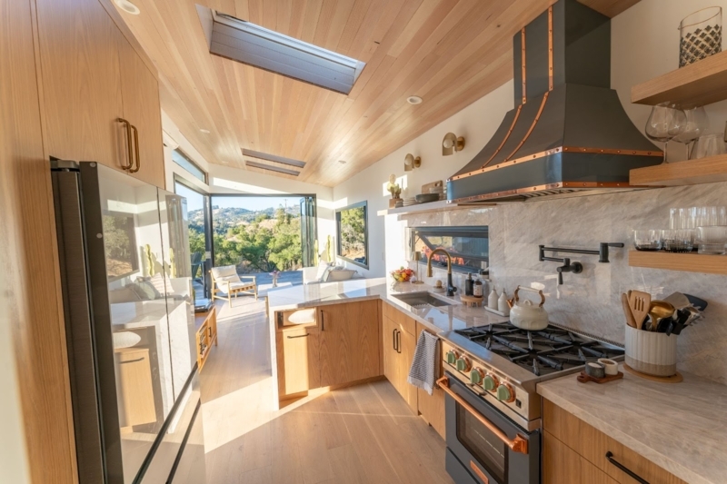 Tiny Home Kitchen with Integrated Skylights and Wood Slat Ceiling