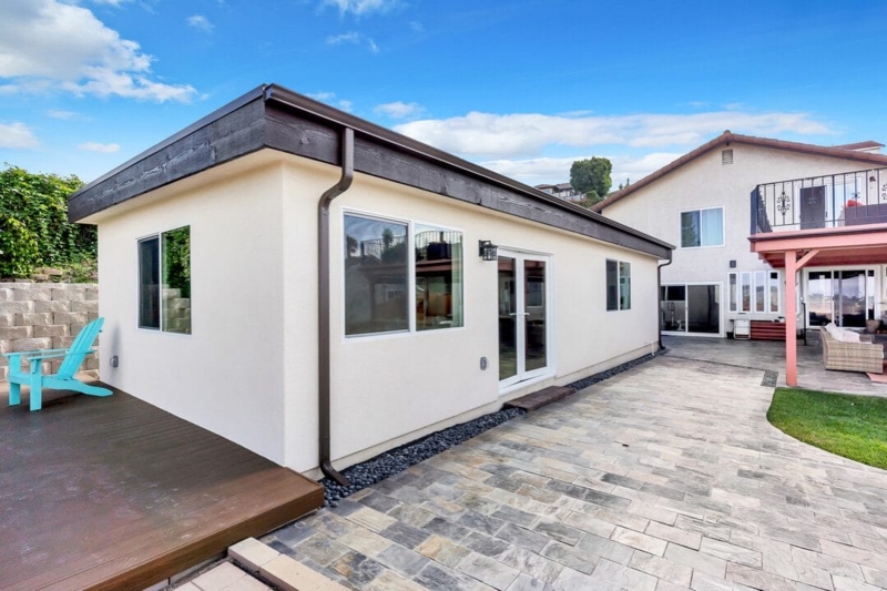 Tiny House Cream Stucco Exterior with Dark Musket Brown Trim Design