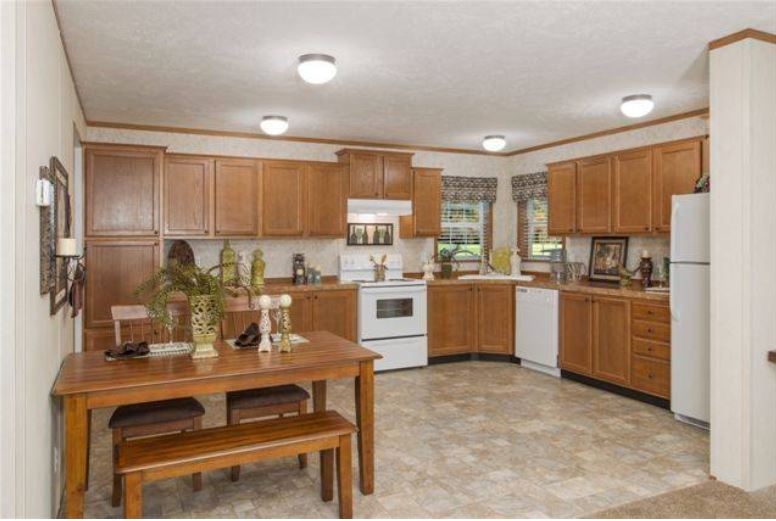 Traditional Farmhouse Kitchen: Wood Cabinets & Dining Table with Bench.