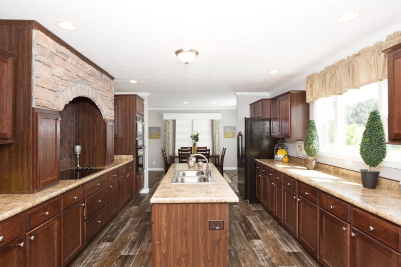 Traditional Kitchen with Stone Arch: Dark Wood Cabinets, Wide Island layout.