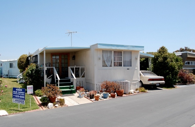 Traditional Mobile Home Entry: Green Carpet & Wooden French Doors