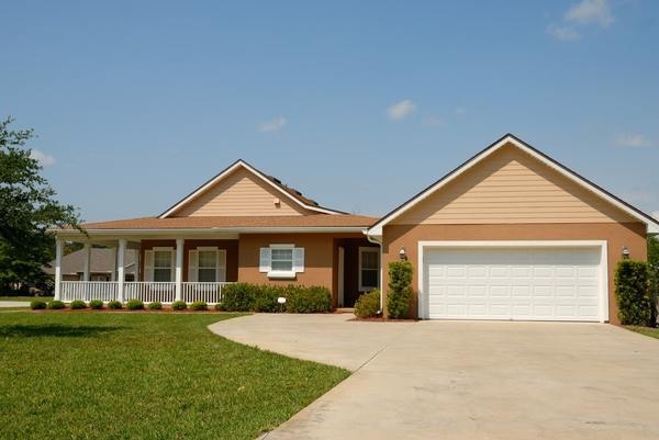 Traditional Ranch Style Home Exterior: Two-Tone Tan Siding & White Garage