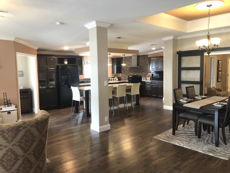 Transitional Dining Area with Zebra Pattern Rug and Espresso Cabinets.