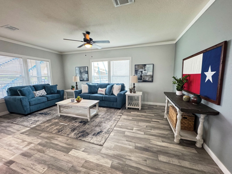 Transitional Living Room: Blue Sofa Set and Texas Flag Art