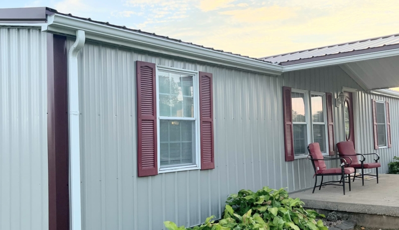 Vertical Metal Siding Renovation with coordinating Maroon Accents