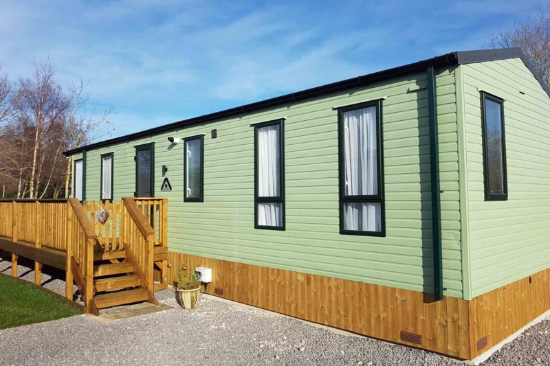 Vertical Wood Skirting with Matching Deck on Sage Green Home