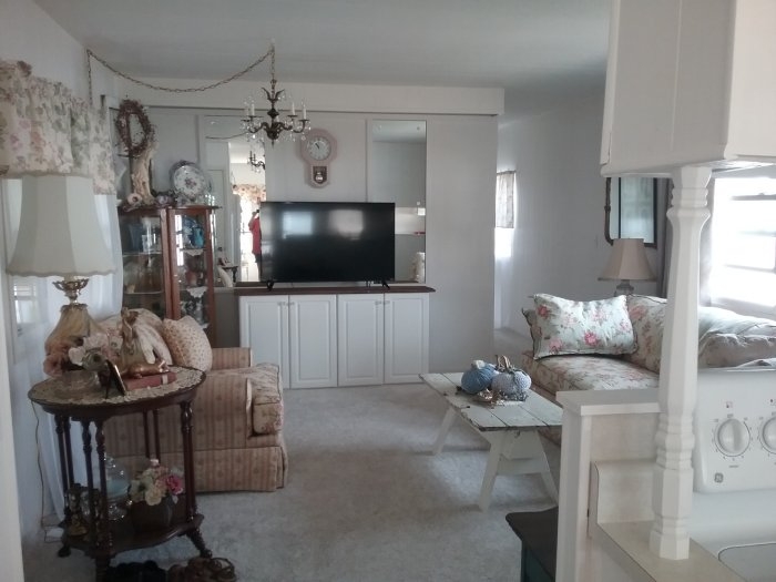 Vintage Cottage Living Room with Floral Upholstery and White Built-ins