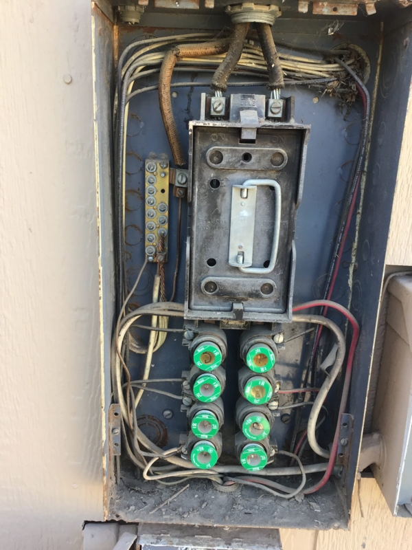Vintage Fuse Box with Green Plug Fuses and Weathered Industrial Finish