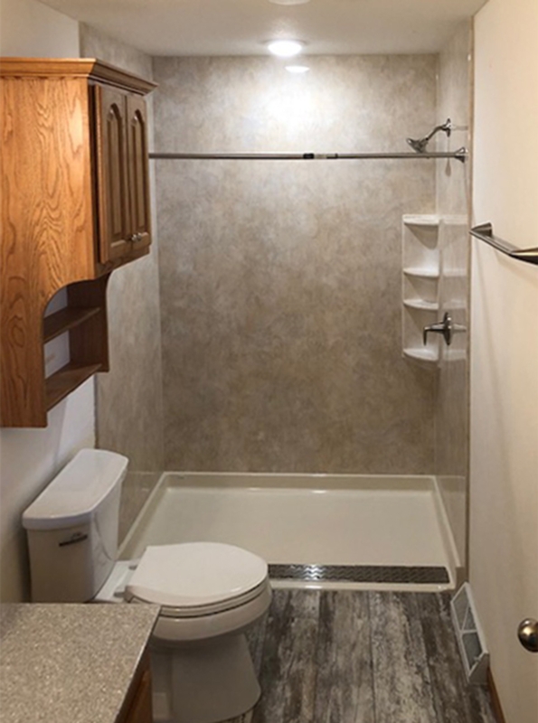 Walk In Shower with Barrier Free Entry and Stone Look Panels.
