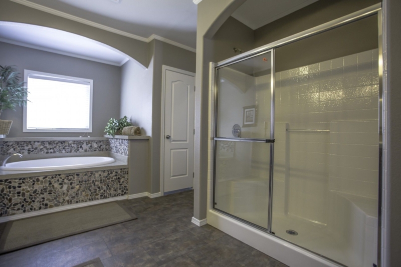 Walk In Shower with Integrated Bench and Pebble Tile Accent.