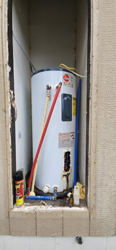 Water Heater with Color Coded PEX Pipes in Exterior Mobile Home Niche