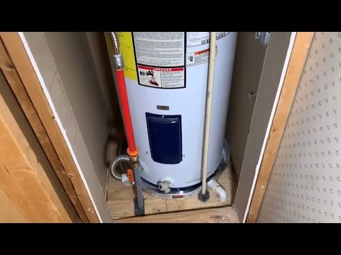 Water Heater with Drain Pan and Red PEX Piping in Compact Utility Fit