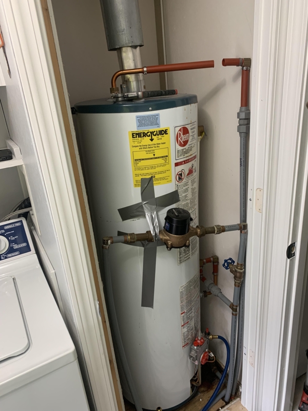 Water Heater with Water Meter Integration in Compact Utility Closet