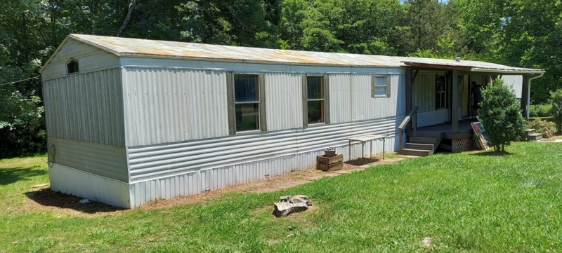 Weathered Corrugated Metal Roof on Silver Sided Home