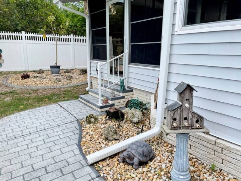 Whimsical Entryway Garden with Animal Statues and Birdhouse