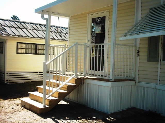 White Aluminum Porch Railing with Natural Wood Steps