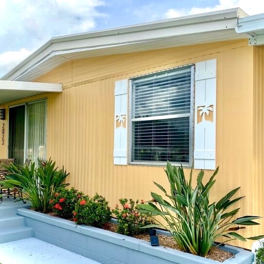 White Coastal Exterior Shutters with Decorative Palm Tree Cutout Design
