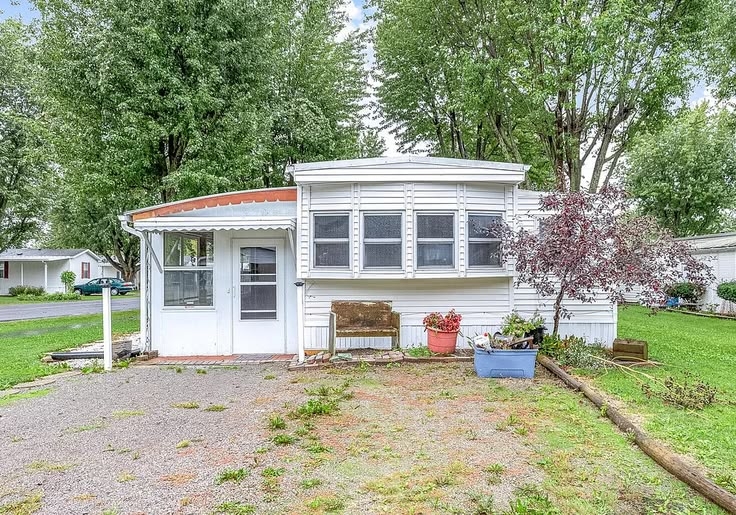 White Mobile Home Exterior Makeover with Bay Window Addition