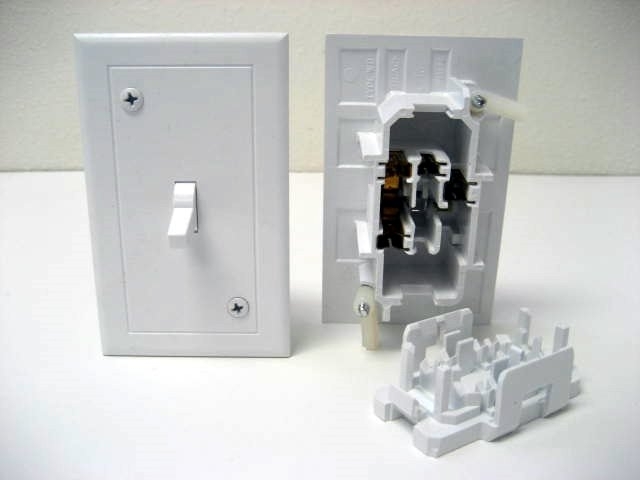 White Plastic Light Switch featuring Classic Toggle Design and Faceplate