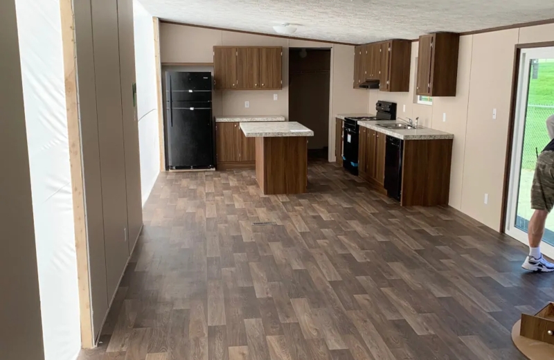 Wood Look Vinyl Plank Flooring in Open Concept Mobile Home Kitchen.