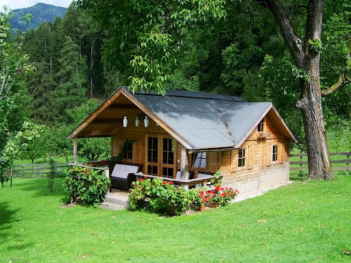 Wooden Cabin Rustic Retreat with Covered Porch and Horizontal Siding