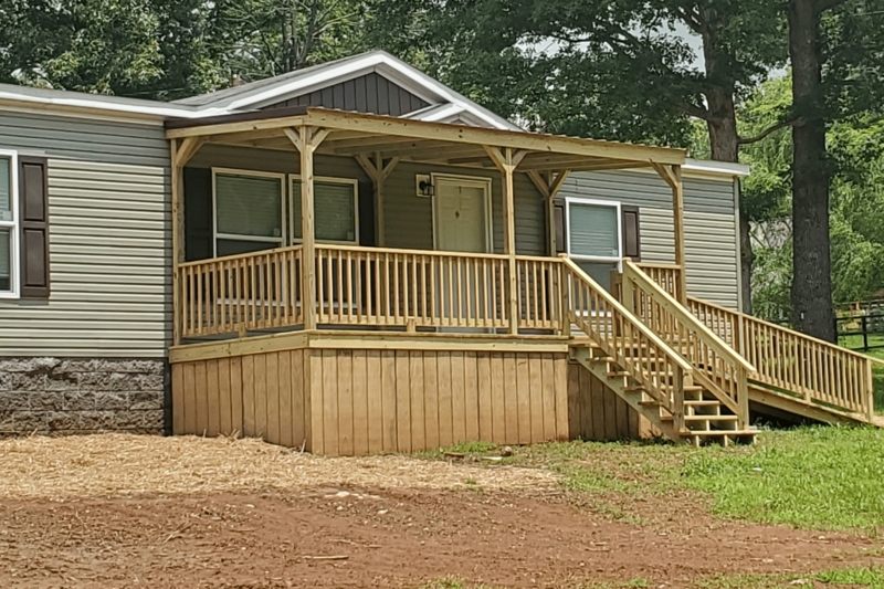 Wooden Mobile Home Deck with Access Ramp and Covered Roof