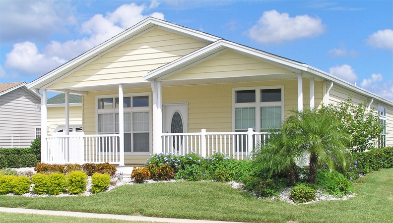 Yellow Manufactured Home Exterior with Wraparound Porch