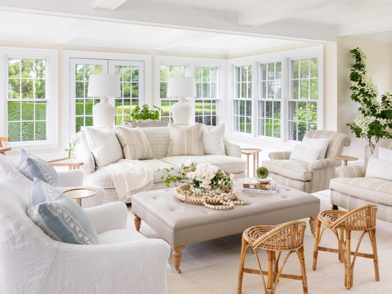 Airy Coastal Sunroom Seating Layout with Tufted Ottoman Coffee Table