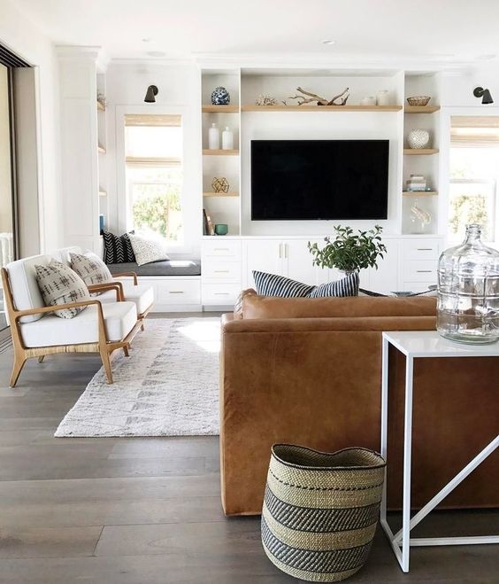Airy Living Room: Built-in Media Center & Tan Leather Sofa