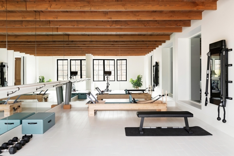 Airy Wellness Studio With Pilates Reformers And Exposed Wood Beams