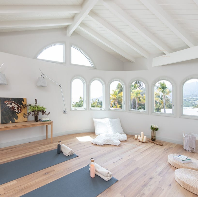 Airy Yoga Studio with Multiple Arched Windows and Vaulted Ceiling