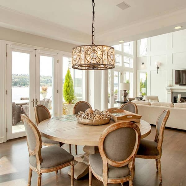 Antique Bronze Drum Chandelier with crystal accents in a dining room.