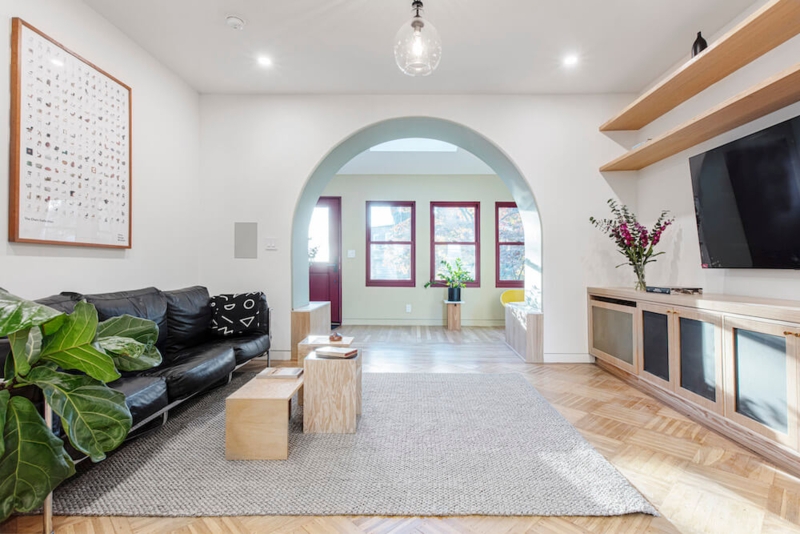 Architectural Archway and Herringbone Flooring Living Room Design