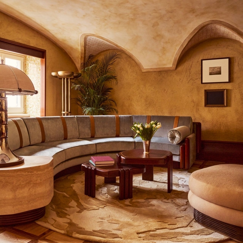 Art Deco Lounge: Vaulted Ceiling, Curved Sectional Sofa, Ochre Walls