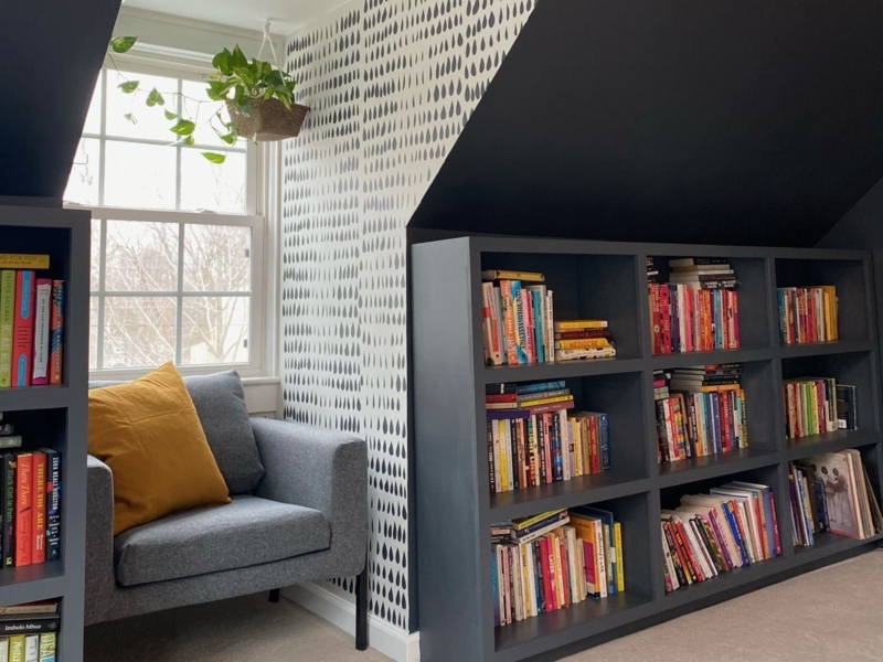 Attic Reading Nook Retreat under slanted ceiling with wallpaper.