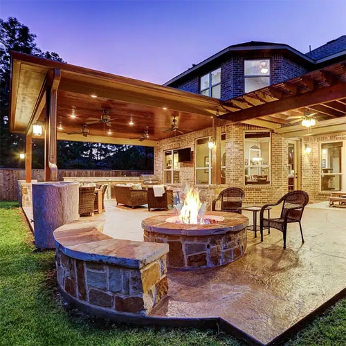 Backyard Patio with Circular Stone Fire Pit and Integrated Seating