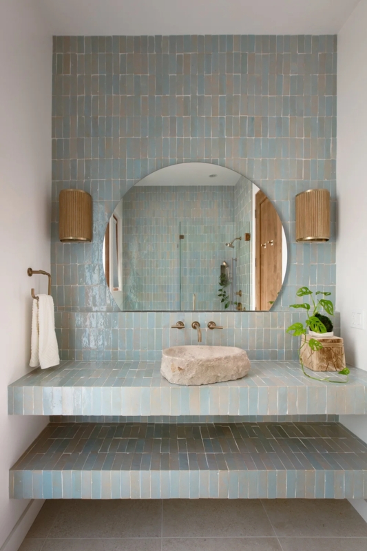 Bathroom with Tiled Walls, Stone Vessel Sink and Arched Mirror