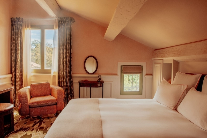 Bedroom in Attic with Terracotta Walls and Exposed Beams
