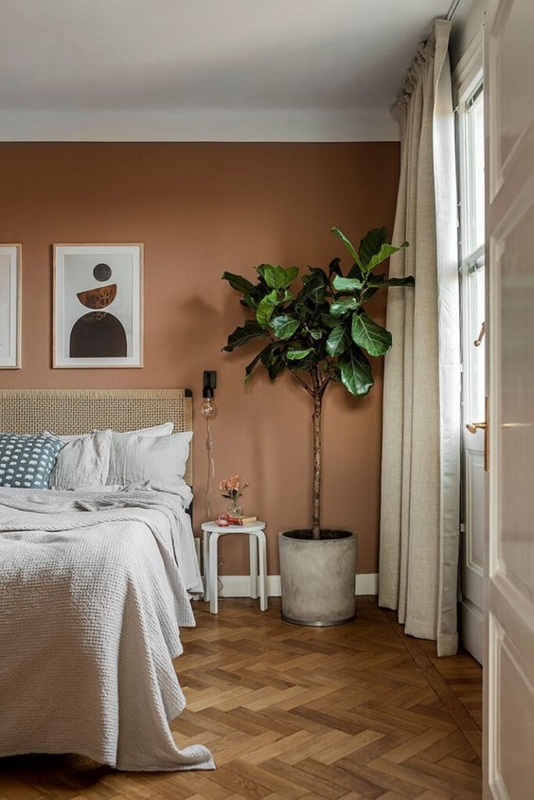 Bedroom with Herringbone Wood Floor, Waffle Knit Bedding and Plants
