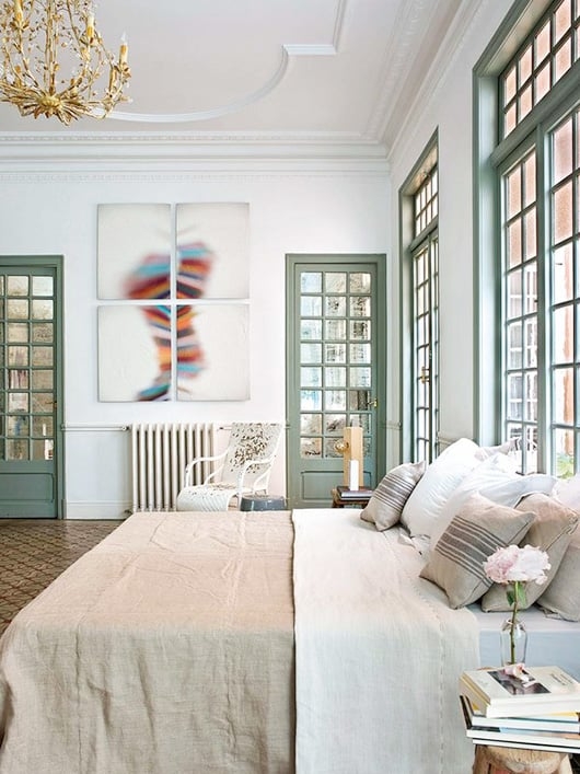 Bedroom with Ornate Gold Chandelier and Sage Green French Doors