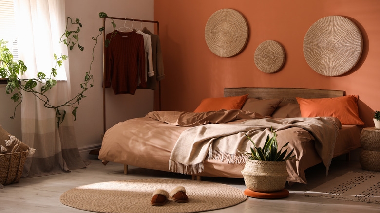 Bedroom with Terracotta Accent Wall and Woven Wall Hanging Gallery