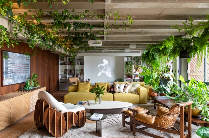 Biophilic Living Room: Hanging Plant Canopy & Mustard Yellow Sofa