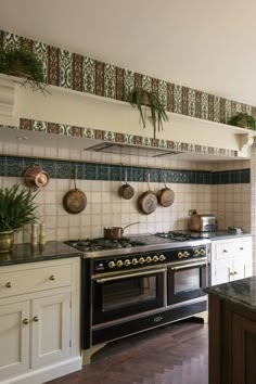 Black Range Cooker in Traditional Kitchen with Hanging Copper Cookware