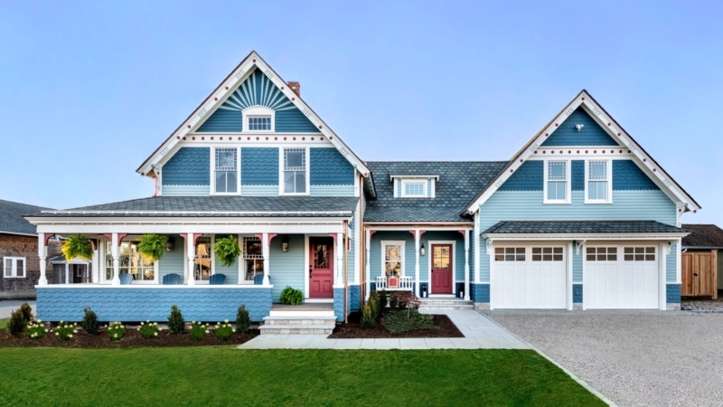 Blue Coastal Home With Red Door Two Tone Facade Ornate Gable Trim