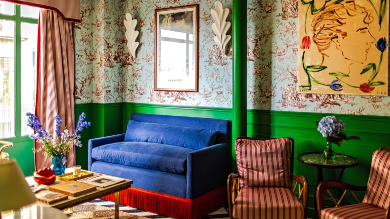 Blue Sofa with Fringe: Emerald Green Wainscoting & Toile Wallpaper
