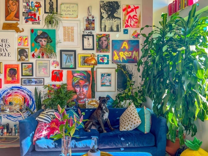 Blue Velvet Sofa in Indoor Jungle Living Room with Dense Gallery Wall