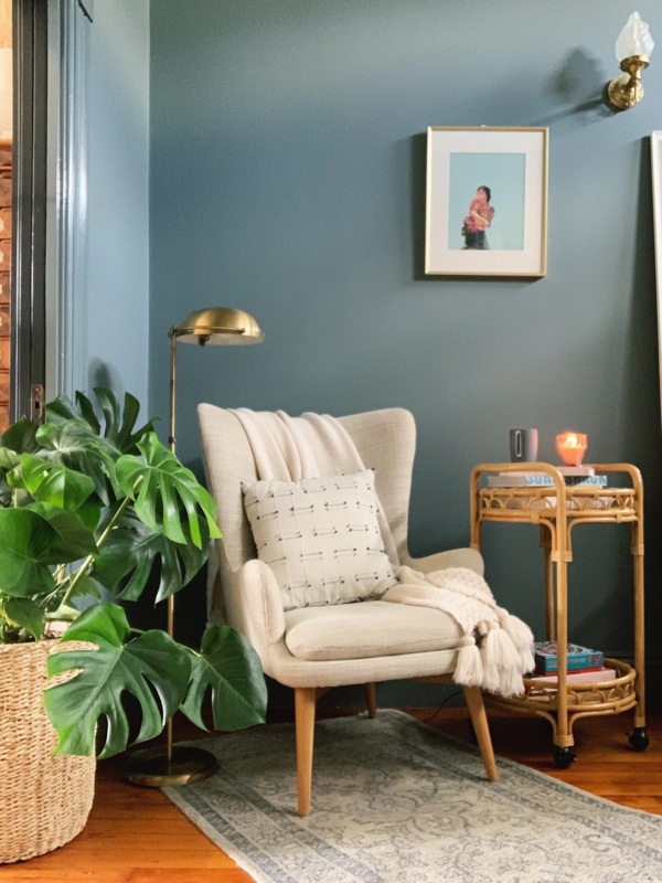 Boho Chic Reading Corner with Teal Accent Wall and Wingback Chair