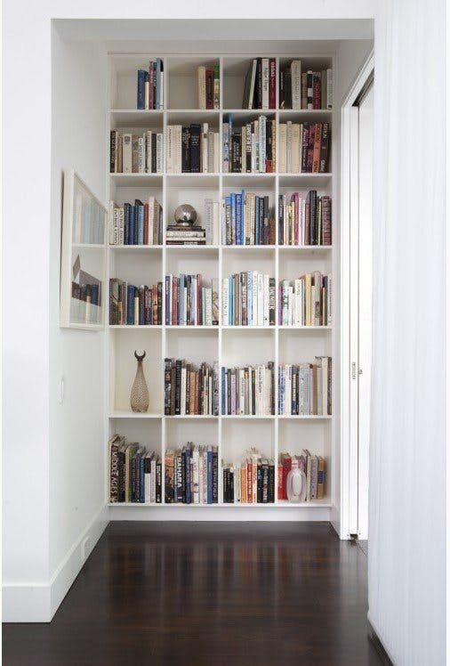 Bookcase: Minimalist Hallway Library Wall with Grid Shelving
