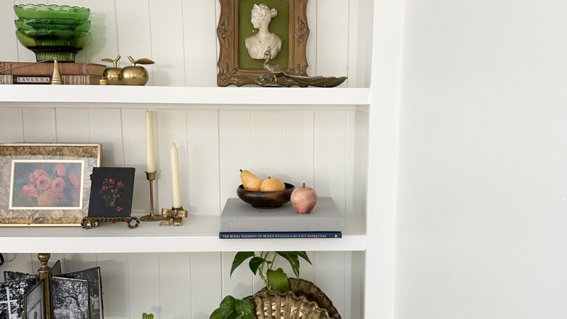 Bookshelf Styling: White Beadboard Backing with Brass & Green Glass